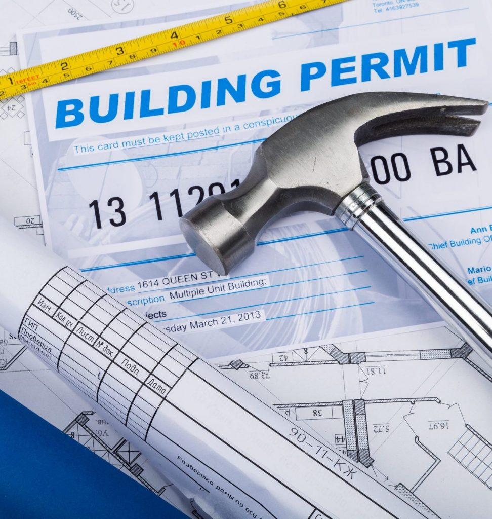 building permit concept with papers and hammer